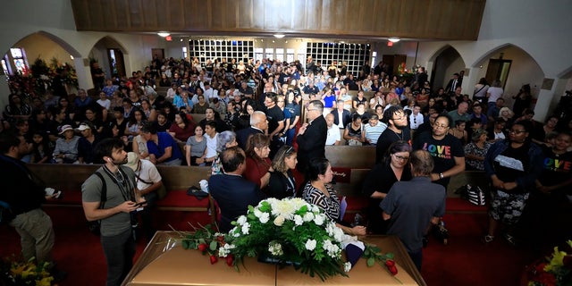 People offering condolences to Antonio Basco, lower right, at her funeral at La Paz Faith Memorial and Spiritual Center in El Paso this past Friday. (AP Photo/Jorge Salgado)