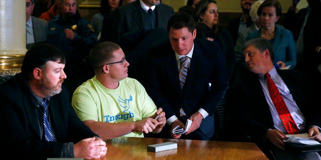 FILE - In this Dec. 19, 2016, file photo, Colorado elector Micheal Baca, second from left, talks with legal counsel after he was removed from the panel for voting for a different candidate than the one who won the popular vote, during the Electoral College vote at the Capitol in Denver. Colorado Secretary of State Wayne Williams, front right, looks on. On Tuesday, Aug. 20, 2019, the 10th U.S. Circuit Court of Appeals ruled that Williams violated the Constitution when he removed Baca from the panel. (AP Photo/Brennan Linsley, File)