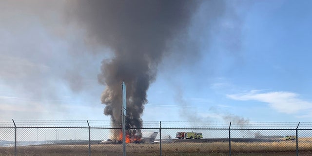 The plane slipped from the end of the runway into the grass and caught fire. (California Highway Patrol via AP)