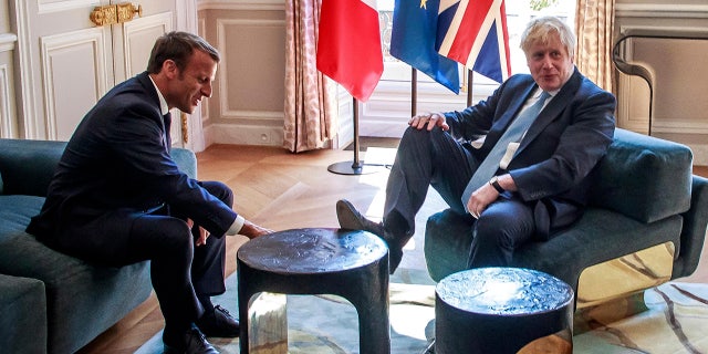 French President Emmanuel Macron, left, talks to Britain's Prime Minister Boris Johnson during their meeting at the Elysee Palace, Thursday, Aug. 22, 2019 in Paris.