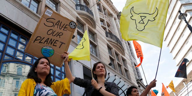 Extinction Rebellion activists protest outside the Brazilian Embassy in London, Friday, Aug. 23, 2019, to call on Brazil's President Jair Bolsonaro to act to protect the Amazon rainforest.