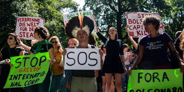 Protestors gather to demonstrate against the Brazilian government and the fires in the Amazon in Berlin, Friday Aug. 23, 2019.