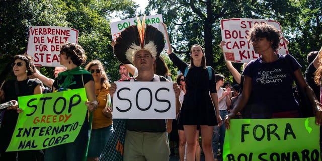 Protestors gather to demonstrate against the Brazilian government and the fires in the Amazon in Berlin, Friday Aug. 23, 2019.