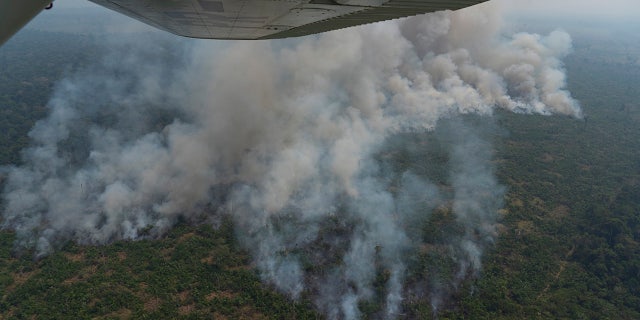 Fire consumes an area near Porto Velho, Brazil, Friday, Aug. 23, 2019. Brazilian state experts have reported a record of nearly 77,000 wildfires across the country so far this year, up 85% over the same period in 2018. Brazil contains about 60% of the Amazon rainforest, whose degradation could have severe consequences for global climate and rainfall. (AP Photo/Victor R. Caivano)