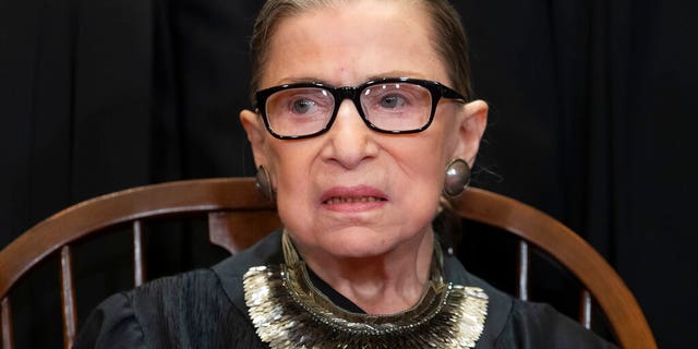 FILE - In this Nov. 30, 2018 file photo, Associate Justice Ruth Bader Ginsburg sits with fellow Supreme Court justices for a group portrait at the Supreme Court Building in Washington. The Supreme Court announced Aug. 23, 2019, that Ginsburg has been treated for a malignant tumor. (AP Photo/J. Scott Applewhite, File)