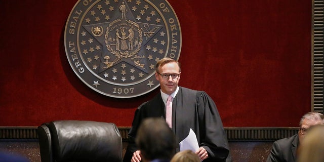 Judge Thad Balkman arrives to give his decision in the Opioid Lawsuit in Norman, Okla., Monday, Aug. 26, 2019. Balkman found Johnson & Johnson and its subsidiaries helped fuel the state's opioid drug crisis and ordered the consumer products giant to pay $572 million to help abate the problem in the coming years. (AP Photo/Sue Ogrocki, Pool)