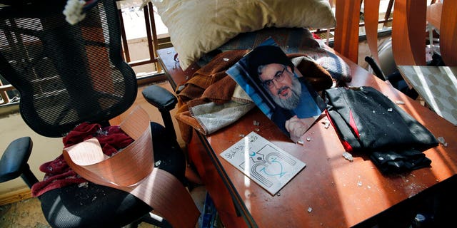 Aug. 25, 2019: Hezbollah leader Sayyed Hassan Nasrallah lies amid other damage inside the Lebanese Hezbollah media office, in a southern suburb of Beirut, Lebanon. The long shadow war between Israel and Iran has burst into the open in recent days, with Israel allegedly striking Iran-linked targets as far away as Iraq and crash-landing two drones in Lebanon. These incidents, along with an air raid in Syria that Israel says thwarted an imminent Iranian drone attack, have raised tensions at a particularly fraught time. (AP Photo/Bilal Hussein)