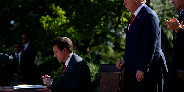 President Trump watching as Defense Secretary Mark Esper signed a document announcing the establishment of the U.S. Space Command. (AP Photo/Evan Vucci)