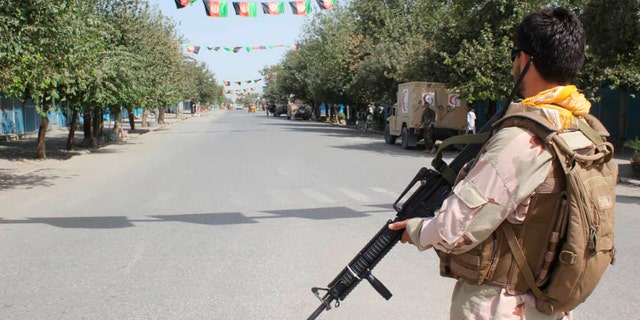 Afghan security forces stand guard during a fight against Taliban fighters in Kunduz province north of Kabul, Afghanistan, Saturday, Aug. 31, 2019. The Taliban have launched a new large-scale attack on one of Afghanistan's main cities, Kunduz, and taken hospital patients as hostages, the government said Saturday, even as the insurgent group continued negotiations with the United States on ending America's longest war. (AP Photo/Bashir Khan Safi)