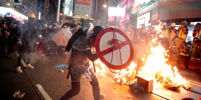 A protester uses a shield to cover himself in front of the police in Hong Kong, Saturday, August 31, 2019. Protesters and police are held in Hong Kong on a street that crosses the bustling shopping area of ​​Causeway Bay. (AP Photo / Jae C. Hong)