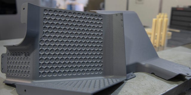 Latrine covers, the first aircraft parts authorized for use after being printed on the Stratasys F900 3D printer are on display Aug. 15, 2019, at Travis Air Force Base, California.