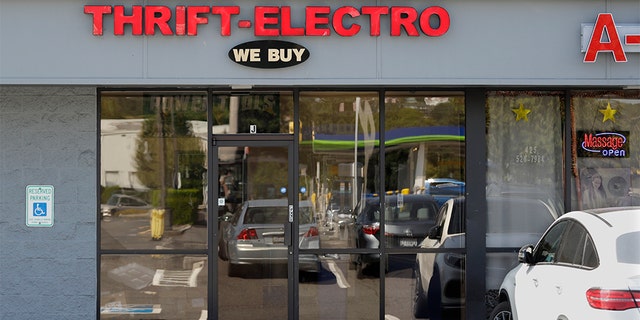In this Wednesday, July 31, 2019, photo a pawn shop alleged to have been a front for a theft ring stands closed in Renton, Wash. The FBI says the ring sold millions of dollars' worth of stolen goods on Amazon.com in the past six years, and that a pair of Amazon delivery drivers was involved. No charges have yet been filed.