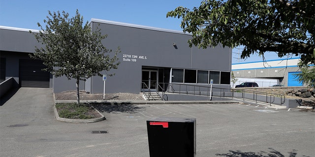 In this Wednesday, July 31, 2019, photo a building that used to house office and storage space for a pawn shop alleged to have been a front for a theft ring stands empty in Kent, Wash.