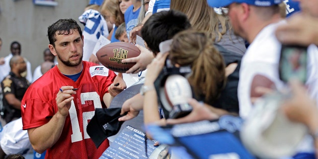 Indianapolis Colts quarterback Andrew Luck (12) signs autographs for fans following the NFL football team's practice in Indianapolis. (AP Photo/Darron Cummings, File)