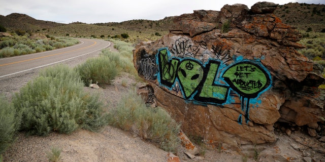 In this July 22, 2019 file photo, alien-themed graffiti adorns a rock along the Extraterrestrial Highway, near Rachel, Nev.