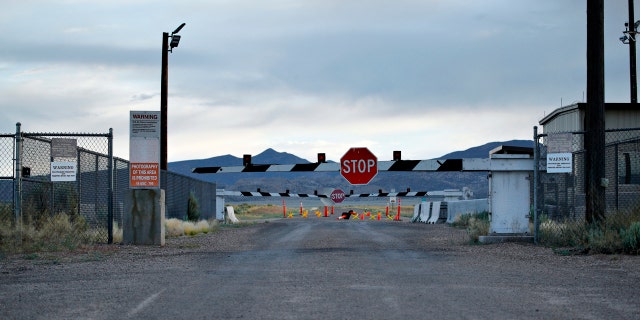 In this July 22, 2019 file photo, signs warn about trespassing at an entrance to the Nevada Test and Training Range near Area 51 outside of Rachel, Nev.