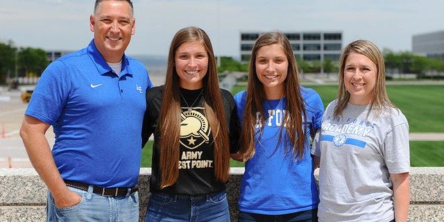 Aubrie and Emma Kuhrt (center), twin sisters from Texas who split to attend separate U.S. military academies, with their parents, Michael (left) and Shannon (right). (U.S. Air Force Academy Public Affairs)