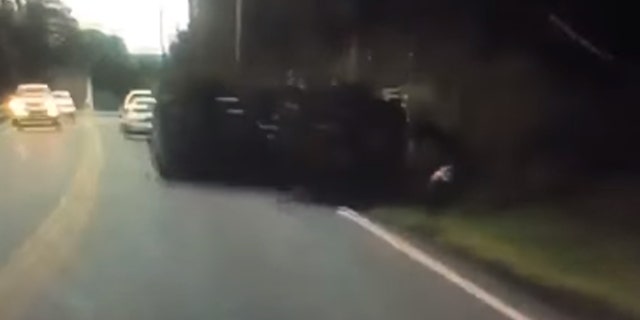 A vehicle can be seen flipping over after striking a utility pole in Massachusetts on July 23.