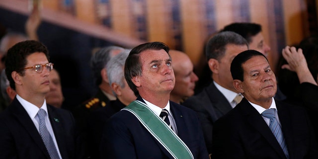 Brazil's President Jair Bolsonaro, Environment Minister Ricardo Salles and Vice President Hamilton Mourao attend a swearing-in ceremony for the country's new army commander in Brasilia, Brazil January 11, 2019.