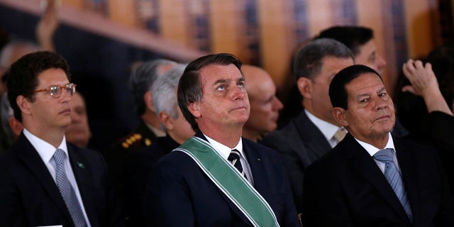 Brazil's President Jair Bolsonaro, Environment Minister Ricardo Salles and Vice President Hamilton Mourao attend a swearing-in ceremony for the country's new army commander in Brasilia, Brazil January 11, 2019.