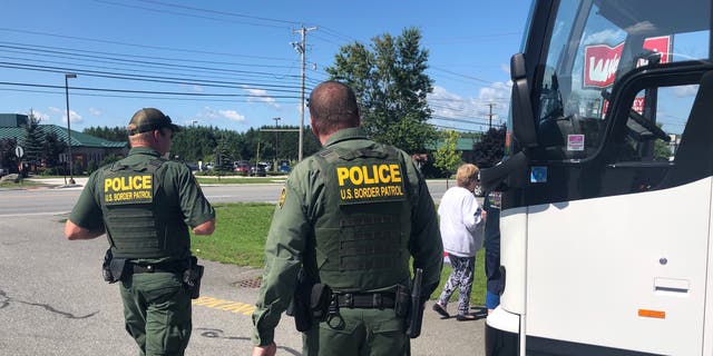 U.S. Customs and Border Protection agents conduct an immigration check at a bus stop in Bangor, Maine.