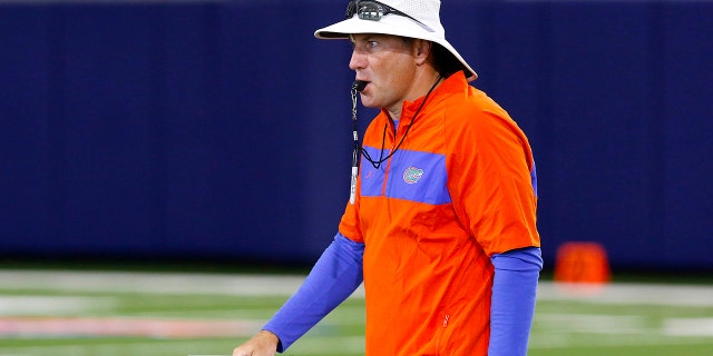 Florida head coach Dan Mullen walks during an NCAA college football practice in Gainesville, Fla., Friday, July 26, 2019. (Brad McClenny/The Gainesville Sun via AP)