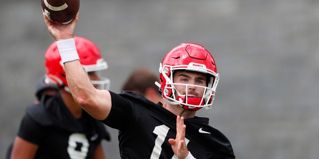 FILE - In this Aug. 2, 2019, file photo, Georgia quarterback Jake Fromm throws a pass during the team's first scheduled NCAA college football practice in Athens, Ga. Georgia fully expects to contend for a national championship. Now, the Bulldogs have to show they can finish the job after coming tantalizingly close the last two seasons. (AP Photo/John Bazemore, File)