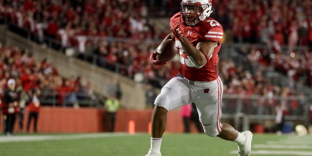 FILE - In this Oct. 6, 2018, file photo, Wisconsin's Jonathan Taylor runs for a touchdown during the second half of an NCAA college football game against Nebraska, in Madison, Wis. College football’s race for its top individual awards this season will have a couple of standout players seeking repeats. Wisconsin’s Jonathan Taylor won the Doak Walker Award as the nation’s top running back last season, while Alabama’s Jerry Jeudy earned the Fred Biletnikoff Award as college football’s most outstanding receiver. Both players are back for their junior seasons. (AP Photo/Morry Gash, File)