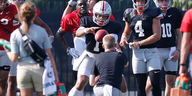 Ohio State quarterback Justin Fields takes a snap during their NCAA college football practice Tuesday, Aug. 6 2019, in Columbus, Ohio. (AP Photo/Jay LaPrete)