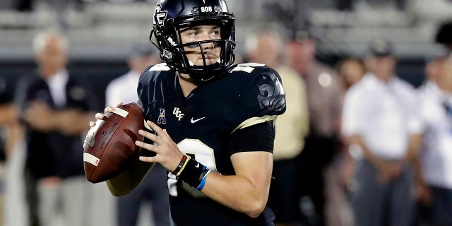 FILE - In this Sept. 21, 2018, file photo, Central Florida quarterback McKenzie Milton looks for a receiver during the first half of an NCAA college football game against Florida Atlantic in Orlando, Fla. Part of the sales pitch that lured Milton from his home state of Hawaii to UCF was a pledge by then-Knights coach Scott Frost to help put the quarterback on a path to a post-playing career in coaching. (AP Photo/John Raoux, File)