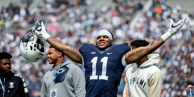 FILE - In this April 21, 2018, file photo, Penn State linebacker Micah Parsons acknowledges the crowd before the Blue-White spring college football game in State College, Pa. Last year, Parsons put together the greatest freshman season for a linebacker in Penn State’s long history. He says he learned that earning a starting spot takes more than making a bunch of tackles. (Joe Hermitt/PennLive.com via AP)