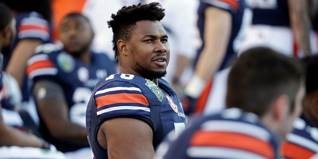 FILE - In this Dec. 28, 2018, file photo, Auburn offensive lineman Prince Tega Wanogho (76) watches from the sideline in the second half of the Music City Bowl NCAA college football game against Purdue, in Nashville, Tenn. Prince Tega Wanogho came to Alabama from Nigeria wanting to be the next LeBron James. He became Auburn’s left tackle instead. (AP Photo/Mark Humphrey, File)