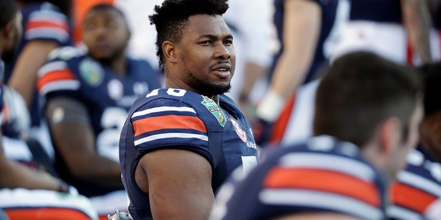 FILE - In this Dec. 28, 2018, file photo, Auburn offensive lineman Prince Tega Wanogho (76) watches from the sideline in the second half of the Music City Bowl NCAA college football game against Purdue, in Nashville, Tenn. Prince Tega Wanogho came to Alabama from Nigeria wanting to be the next LeBron James. He became Auburn’s left tackle instead. (AP Photo/Mark Humphrey, File)