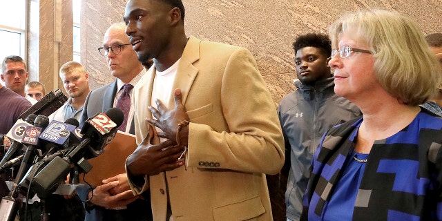 Former Wisconsin Badger football player Quintez Cephus speaks during a press conference to reiterate his request for reinstatement to the university in Madison, Wis. Monday, Aug. 12, 2019. The former wide receiver was acquitted earlier this month of sexual assault charges stemming from a campus incident in his apartment. He was expelled from the university in March after the university's own internal investigation. He is pictured with his attorneys, Stephen Meyer and Kathleen Stilling, as well as a group of current team members were on hand to show support for Cephus at the event. (John Hart/Wisconsin State Journal via AP)