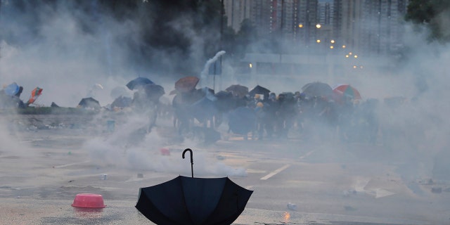 An umbrella is abandoned as protesters pull back from tear gas on Monday, Aug. 5, 2019.