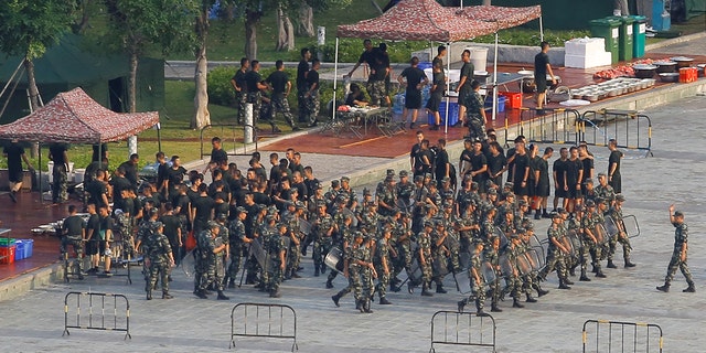 Chinese soldiers walk in formation on the grounds of the Shenzhen Bay Sports Center in Shenzhen across the bay from Hong Kong, China Aug. 15, 2019. 