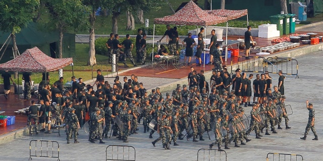 Chinese soldiers walk in formation on the grounds of the Shenzhen Bay Sports Center in Shenzhen across the bay from Hong Kong, China Aug. 15, 2019. 