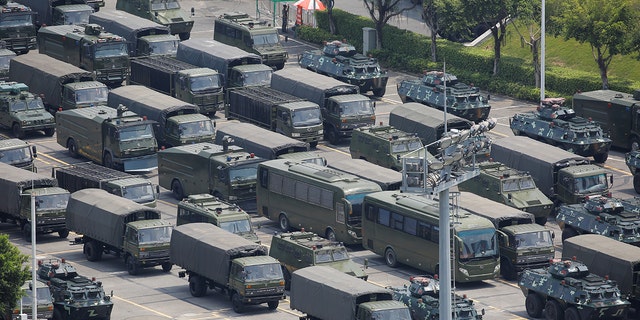 Military vehicles are parked on the grounds of the Shenzhen Bay Sports Center in Shenzhen, China August 15, 2019.