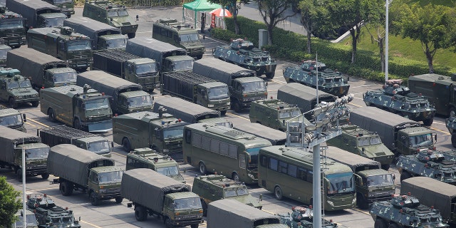 Military vehicles are parked on the grounds of the Shenzhen Bay Sports Center in Shenzhen, China August 15, 2019.