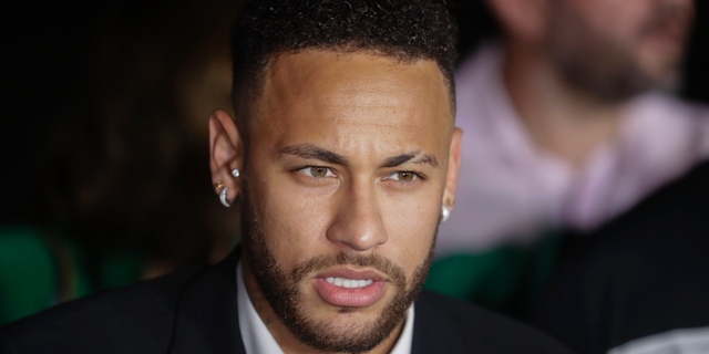 In this June 13, 2019, file photo, Brazil soccer player Neymar speaks to the press as he leaves a police station.