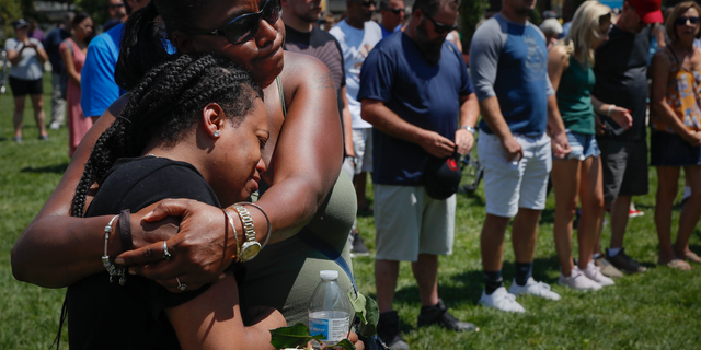 Mourners gather at a vigil following a nearby mass shooting, Sunday, Aug. 4, 2019, in Dayton, Ohio. Multiple people in Ohio have been killed in the second mass shooting in the U.S. in less than 24 hours, and the suspected shooter is also deceased, police said. (AP Photo/John Minchillo)