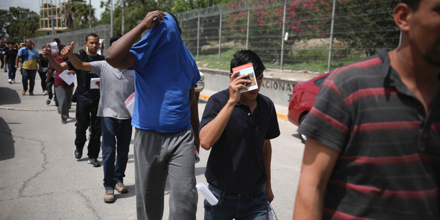 Migrants return to Mexico using the Puerta Mexico bridge that crosses the Rio Grande river in Matamoros, Mexico, July 31, 2019, on the border with Brownsville, Texas. (AP Photo/Emilio Espejel)