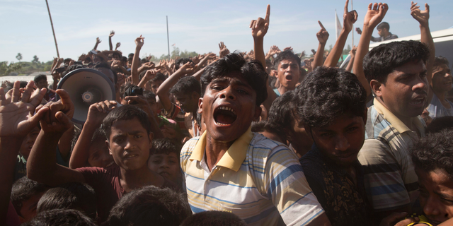 In this file photo dated Thursday, Nov. 15, 2018, Rohingya refugees shout slogans during a protest against the repatriation process at Unchiprang refugee camp near Cox's Bazar, in Bangladesh.