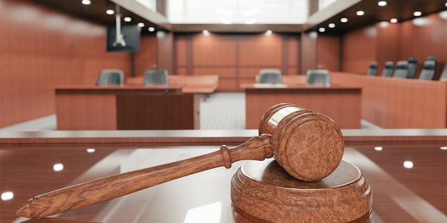 Inside a courtroom with gavel in plain view. 