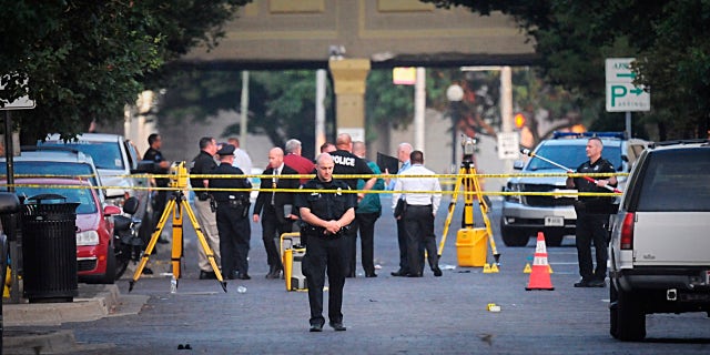 Dayton police look for evidence after a mass shooting in Dayton, Ohio on Sunday, Aug, 4, 2019.