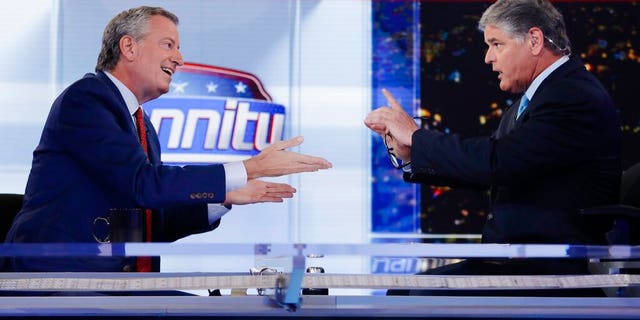 Fox News host Sean Hannity, right, interviews Democratic presidential candidate and New York Mayor Bill de Blasio during a taping of his show, "Hannity." (AP Photo/Frank Franklin II)