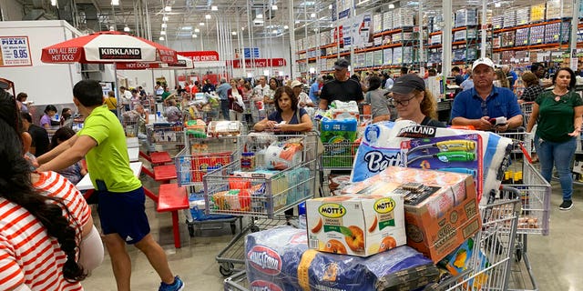 Shoppers wait in long lines at Costco, Thursday, Aug. 29, 2019, in Davie, Fla., as they stock up on supplies ahead of Hurricane Dorian. (AP Photo/Brynn Anderson)