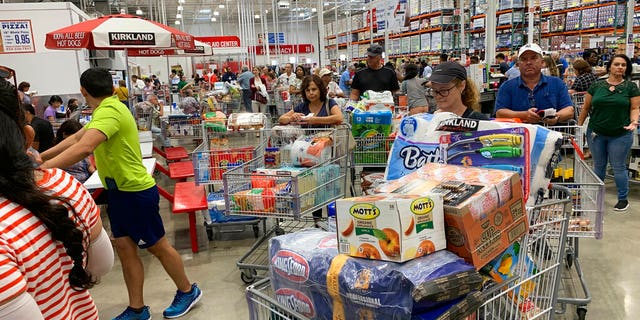 Shoppers wait in long lines at Costco, Thursday, Aug. 29, 2019, in Davie, Fla., as they stock up on supplies ahead of Hurricane Dorian. (AP Photo/Brynn Anderson)