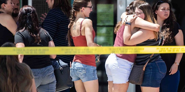 Family members hug to each other outside the family reunification center at MacArthur Elementary-Intermediate School in El Paso, Texas on Sunday, Aug. 4, 2019.