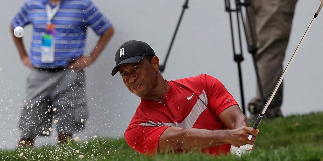 Tiger Woods hits from a bunker on the 13th hole during the final round of the BMW Championship golf tournament at Medinah Country Club, Sunday, Aug. 18, 2019, in Medinah, Ill. (AP Photo/Nam Y. Huh)
